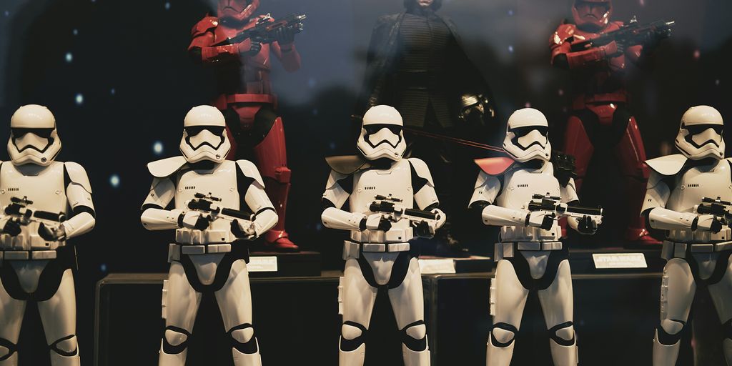 3 women in white and black costume standing on stage