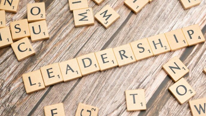 scrabble tiles spelling out the word leadership on a wooden surface