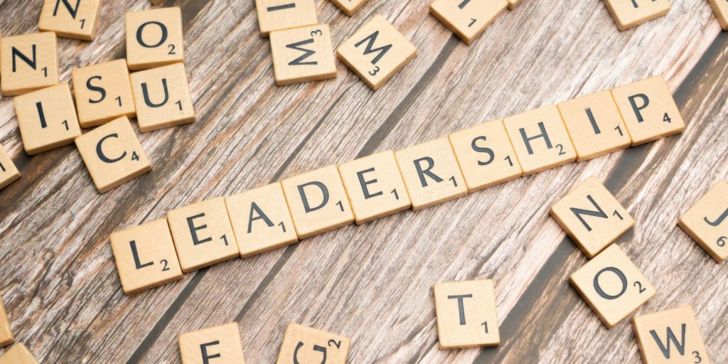 scrabble tiles spelling out the word leadership on a wooden surface