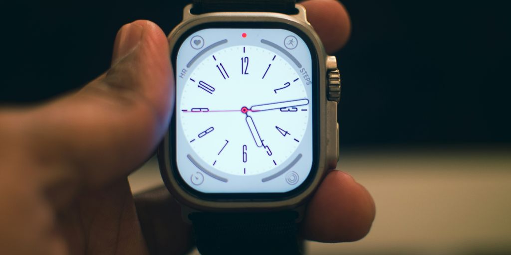 a person holding a smart watch in their hand