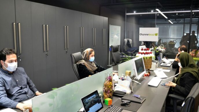 man in black jacket sitting on black office rolling chair