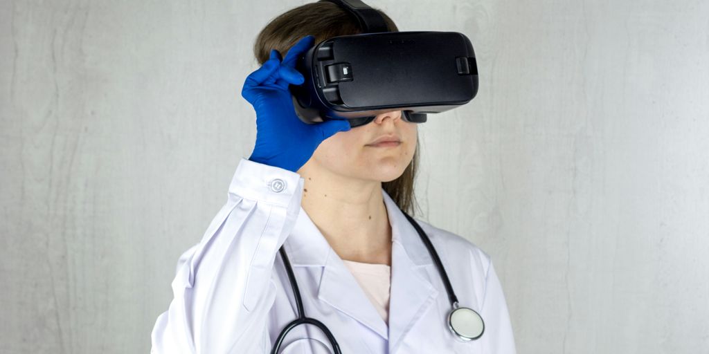 a woman in a white coat and blue gloves is wearing a virtual headset
