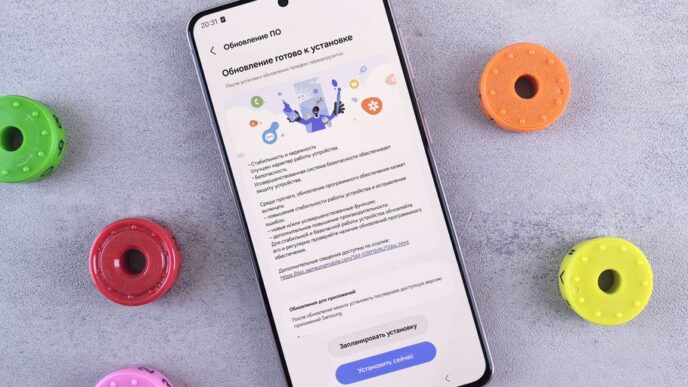 A cell phone sitting on top of a table next to doughnuts