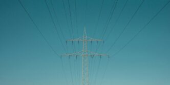 white electric post under blue sky during daytime