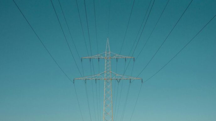 white electric post under blue sky during daytime