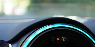 a close up of a car dashboard with a blue light