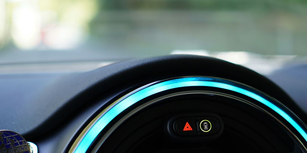 a close up of a car dashboard with a blue light