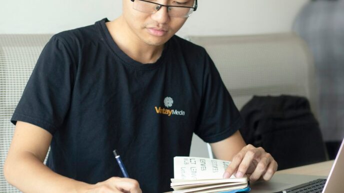 man writing on paper