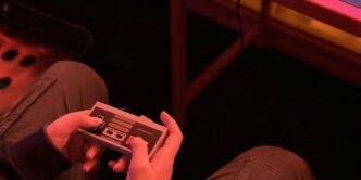 a person sitting on the floor playing a video game