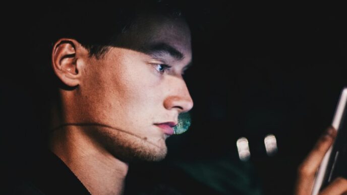 man using phone during nighttime