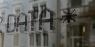 a close up of a window with a building in the background