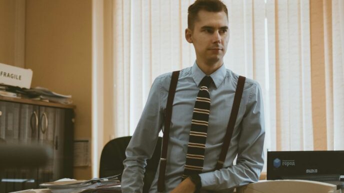 man in gray dress shirt and black necktie