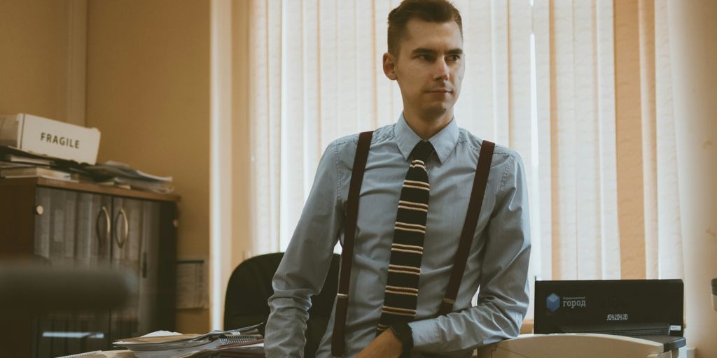 man in gray dress shirt and black necktie