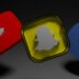 a group of three different colored objects on a black background