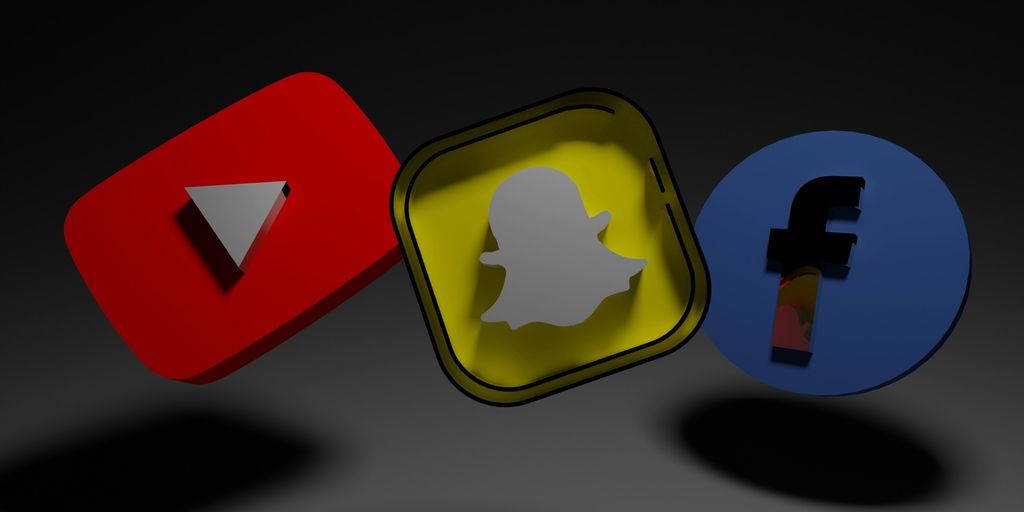 a group of three different colored objects on a black background