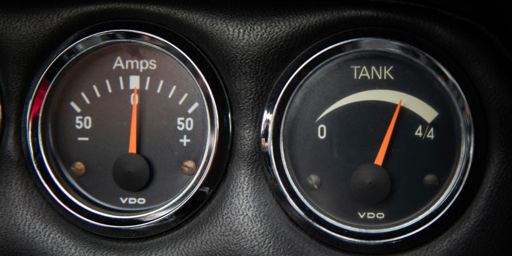 a close up of two gauges in a car