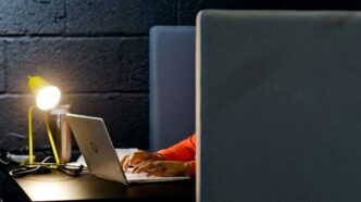 a person working on a laptop in a dark room