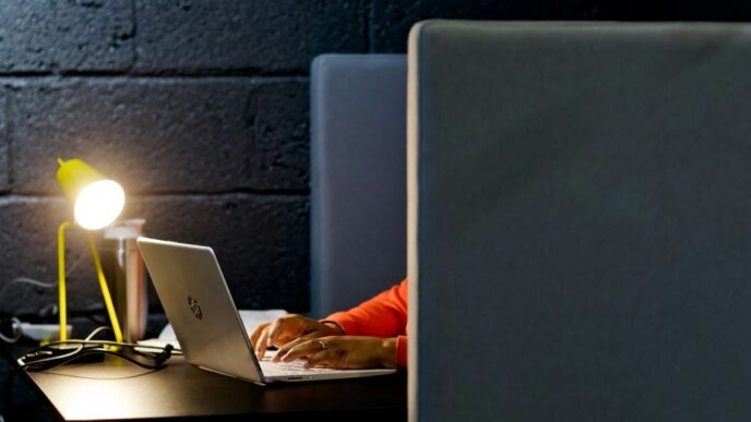 a person working on a laptop in a dark room