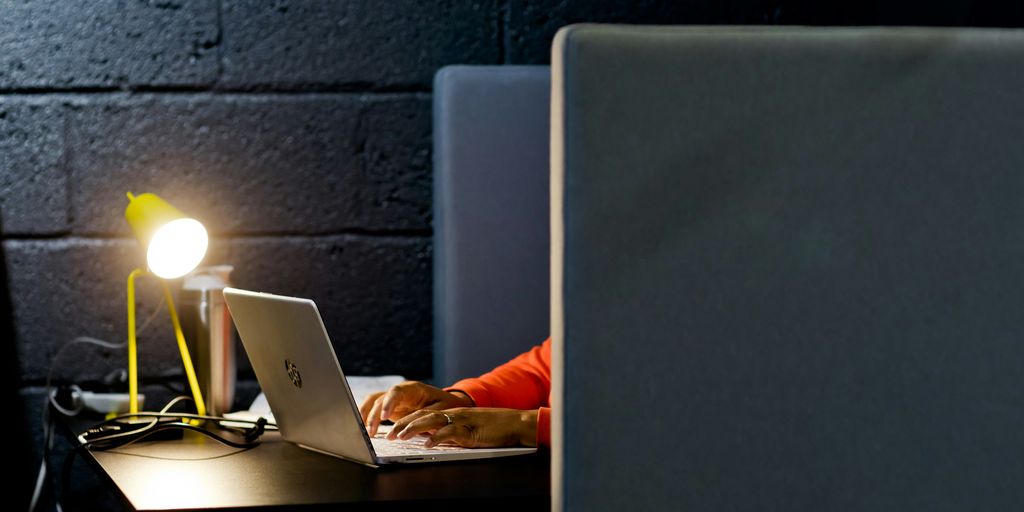 a person working on a laptop in a dark room