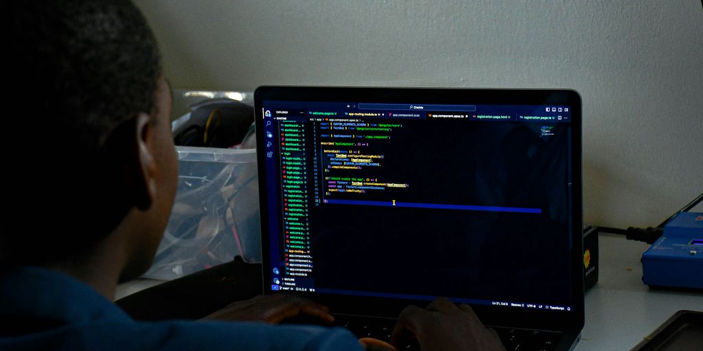a man sitting in front of a laptop computer
