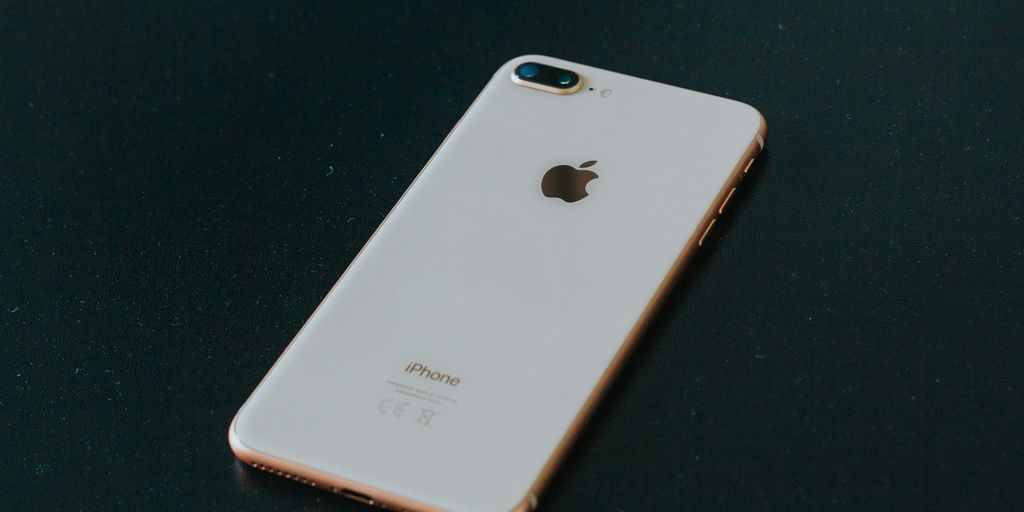 gold iPhone 7 Plus on black surface