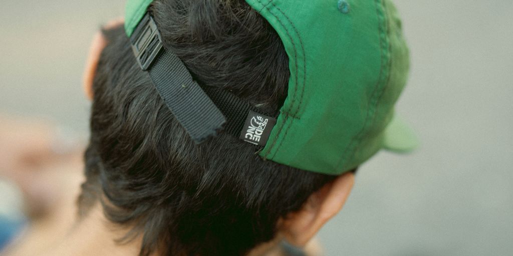 a man with a green hat on top of his head