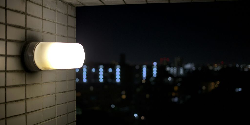 a wall mounted light on a brick wall