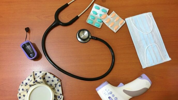 black and silver stethoscope on brown wooden table