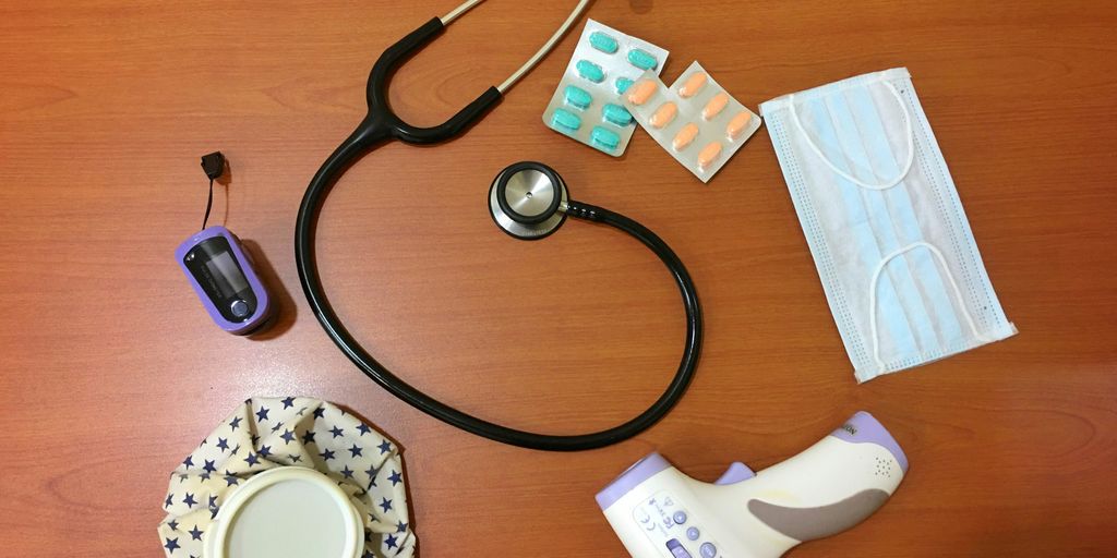 black and silver stethoscope on brown wooden table