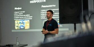 A man standing in front of a projector screen