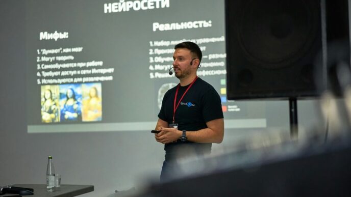 A man standing in front of a projector screen