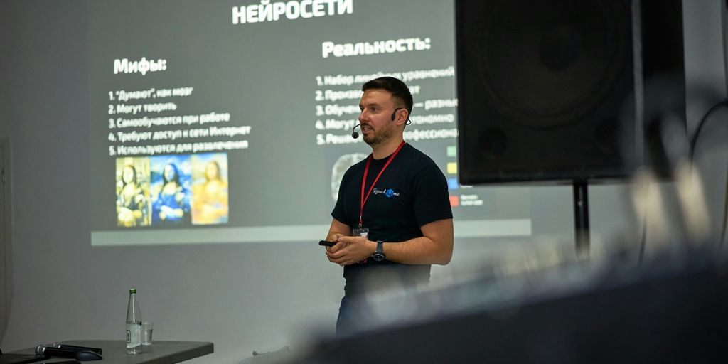 A man standing in front of a projector screen