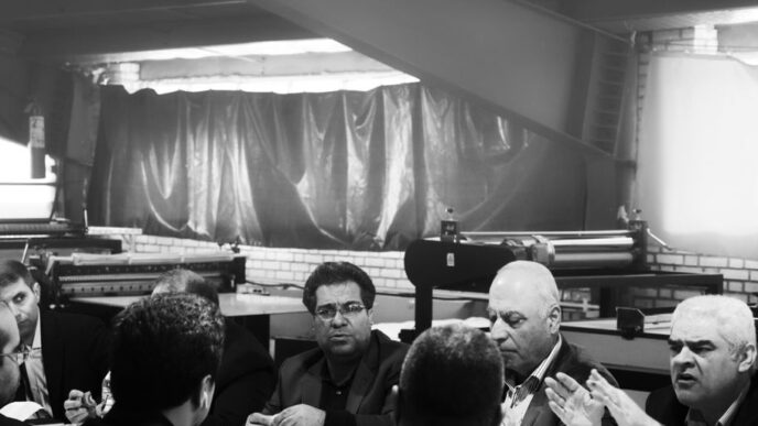 grayscale photography of group of person sitting indoors