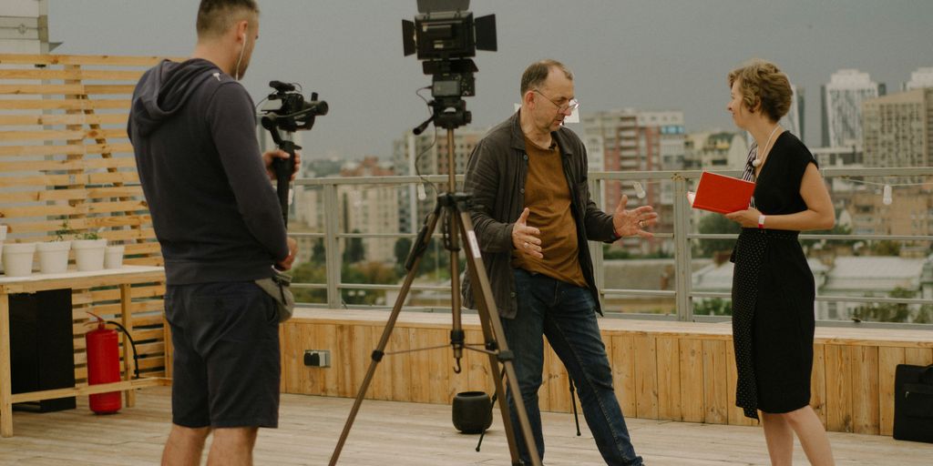 a group of people standing on top of a wooden floor