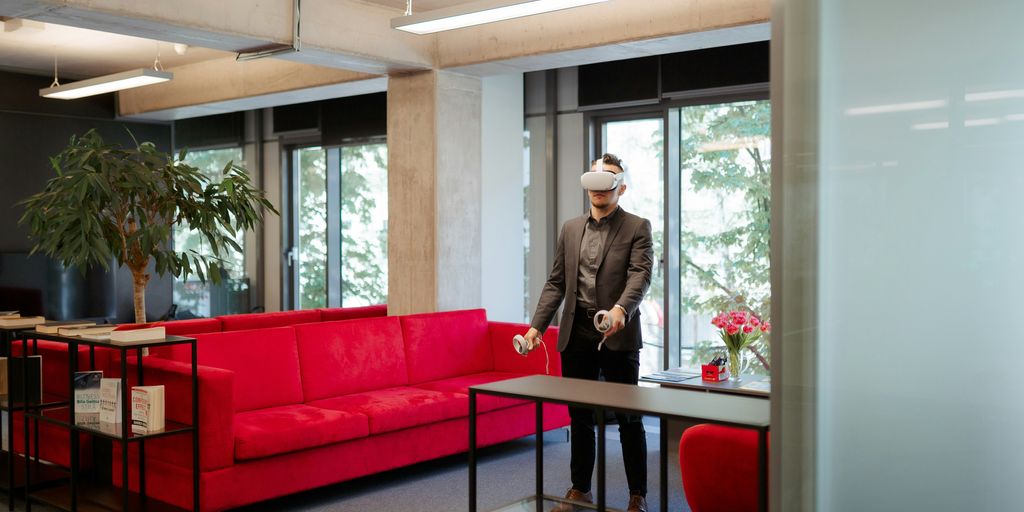 a man standing in a room with a red couch