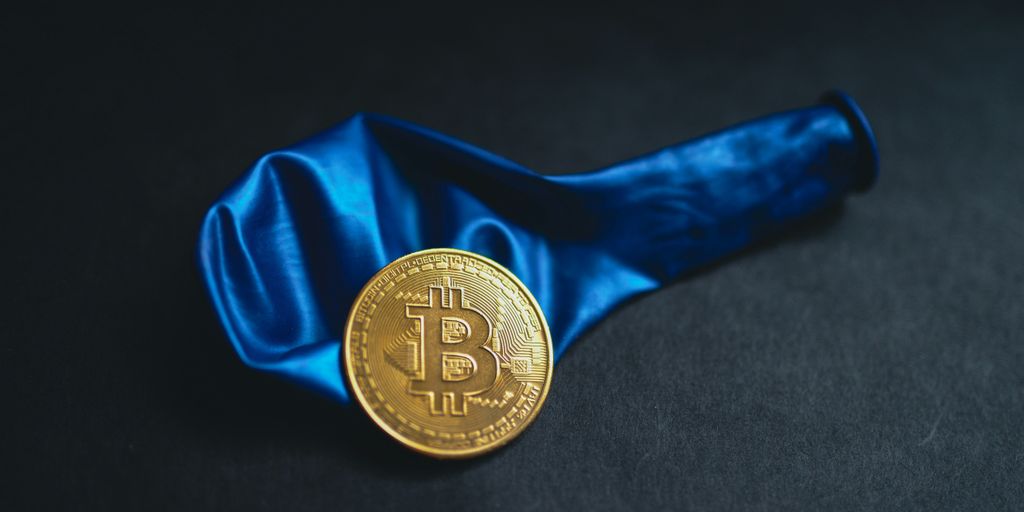 a bitcoin is sitting on a blue cloth