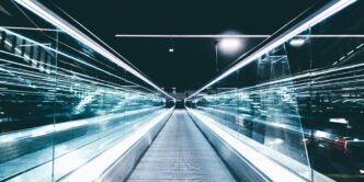 gray conveyor between glass frames at nighttime