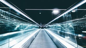gray conveyor between glass frames at nighttime