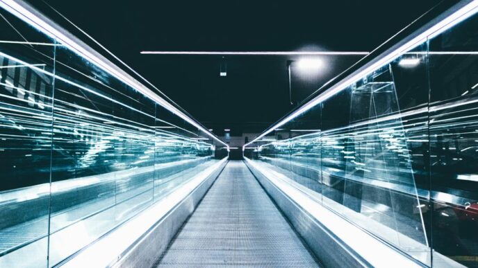 gray conveyor between glass frames at nighttime