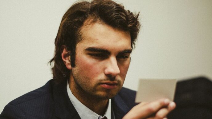 a man in a suit looking at a tablet