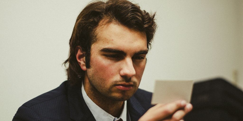 a man in a suit looking at a tablet