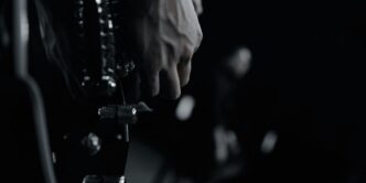 grayscale photo of person holding bottle