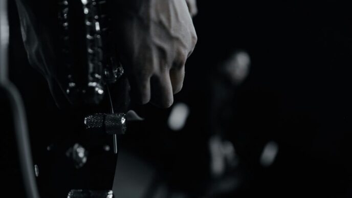grayscale photo of person holding bottle