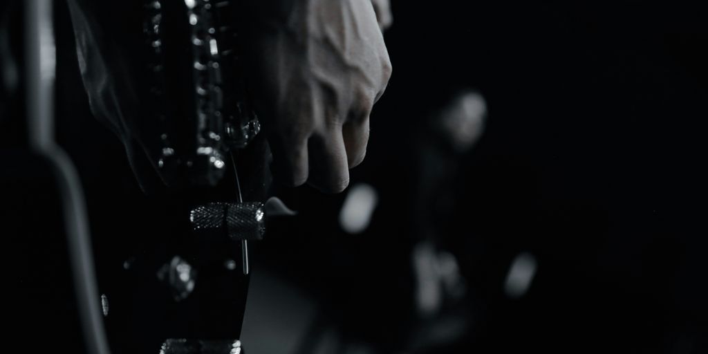 grayscale photo of person holding bottle