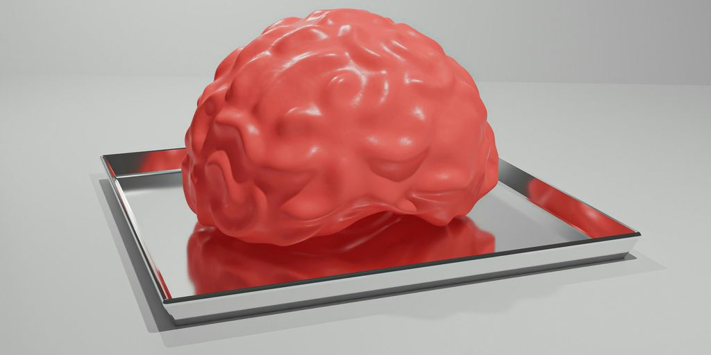 A red brain sitting on top of a metal tray