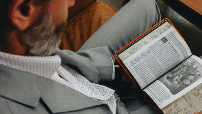 A man sitting in a chair reading a book