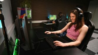 A woman sitting at a desk with headphones on