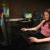 A woman sitting at a desk with headphones on