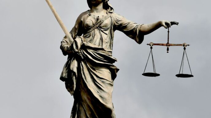 A statue of lady justice holding a sword and a scale