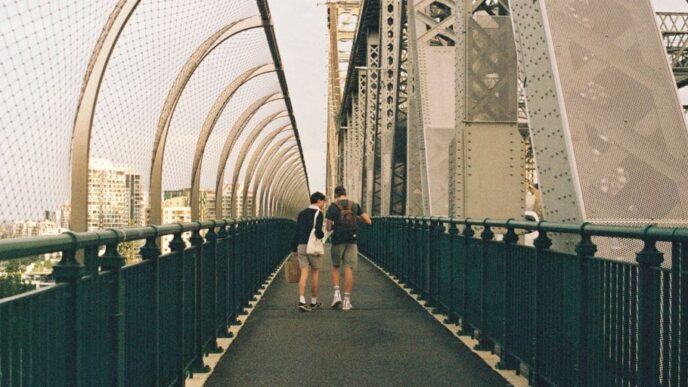 people walking on gray concrete bridge during daytime